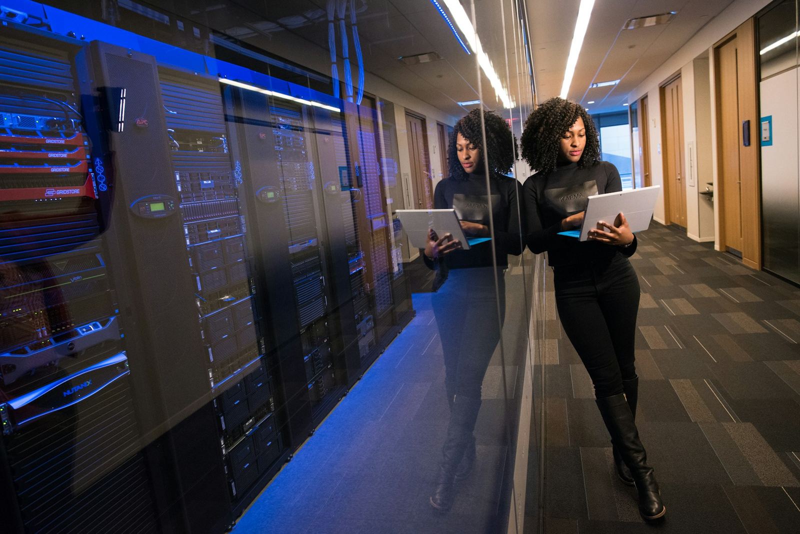 Engineers reviewing systems in a datacenter corridor